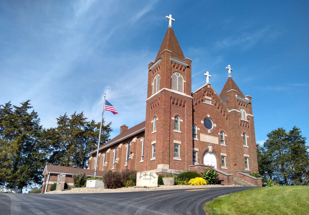 View of the South and East sides of the building from the road via the entrance to the main parking lot.