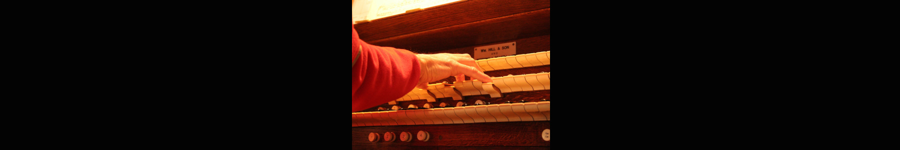 a photo of a church organist playing an organ